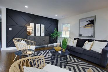 Geometric patterned rug adding visual interest and defining the seating area.