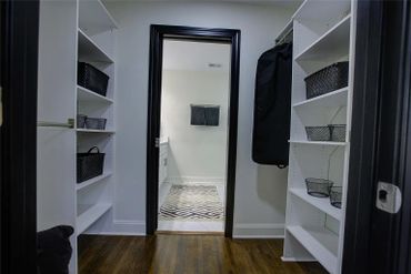 Black framed doorway creating a contrast with the white shelving and walls.