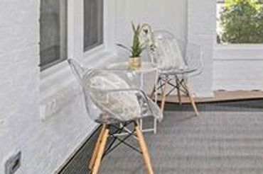 Porch in a [type of rental property] with ample space for relaxation and enjoying the outdoors.