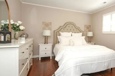 White bedding with decorative pillows creating a cozy and inviting atmosphere.