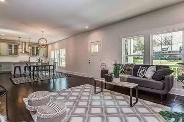 Gray and white geometric rug defining the living room seating area.
