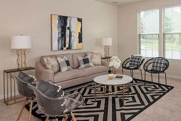 Neutral-colored living room with a focus on comfortable seating and a modern design aesthetic.