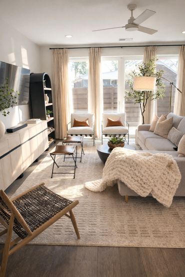 Bright modern living room with neutral tones and cozy textures.