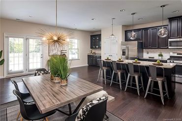 Dining area with a view into the kitchen, creating a sense of connection and openness.