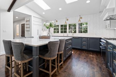 White walls and white trim throughout the kitchen and adjacent space.