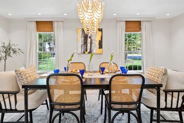 Dining table with place settings, including blue plates and glasses.