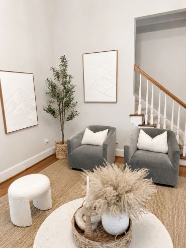 Cozy living area with gray chairs, neutral decor, and natural accents.