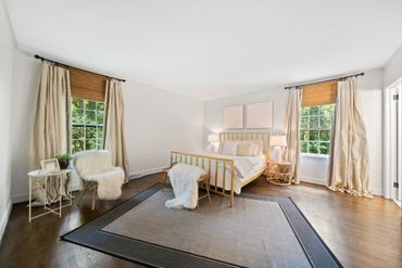 White walls and trim throughout the bedroom.