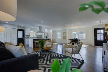 Large windows and a glass door providing natural light and access to an outdoor space.