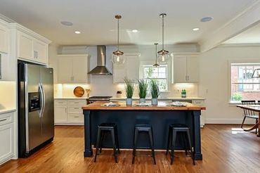 Kitchen featuring a stainless steel refrigerator, microwave, range hood, and dishwasher.