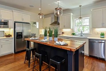 Bright kitchen with recessed lighting, under-cabinet lighting, and a window above the sink.