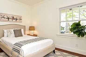 Artwork on the wall above the bed adding a subtle decorative element.