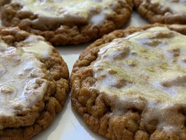 Close-up of oatmeal cookies with a glaze on top.
