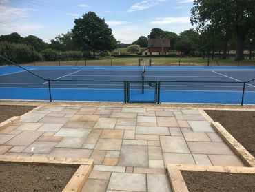 A fenced blue tennis court
