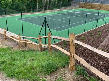Tennis court with wooden fence and acrylic flooring