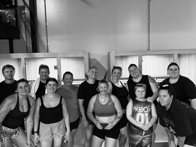 Group of people posing together after a workout session.