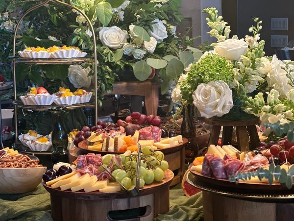 Elegant charcuterie boards with flowers.