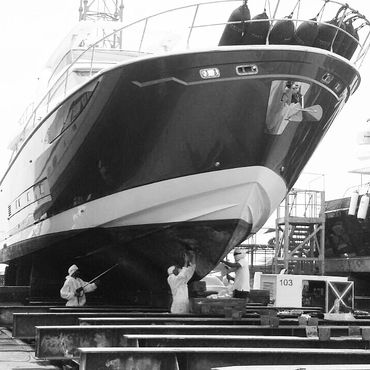 XTL marine's workers performing Antifouling Services on a big yacht