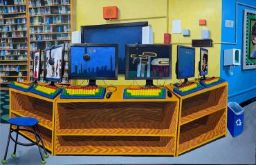 Colorful computer station with multiple monitors in a library.