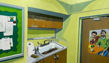 Artistic room corner with sink, drawings, and painted door.