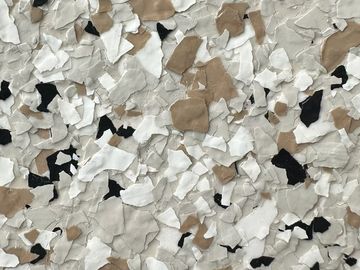 Speckled surface with white, tan, black, and gray pieces.
