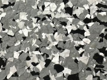 A textured surface with black, white, and gray flakes.