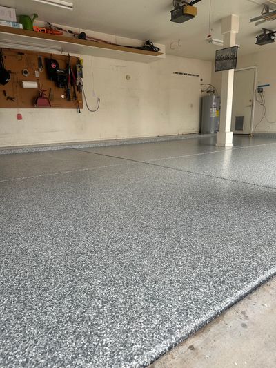 Clean and shiny garage floor with tools hung on wall.