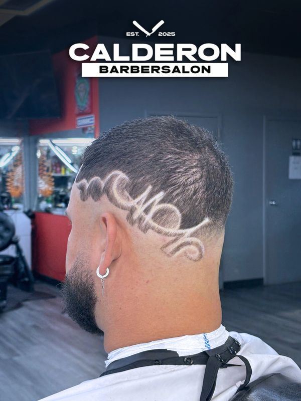 Man with a creative haircut design at Calderon Barbersalon.