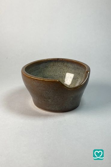 Small ceramic bowl with a spout, glazed in earthy tones.