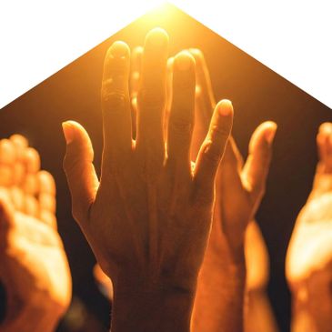 Hands raised in warm golden light, symbolizing unity and hope.