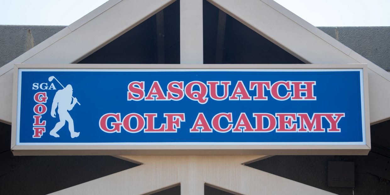 Sasquatch Golf Academy sign with Bigfoot silhouette.