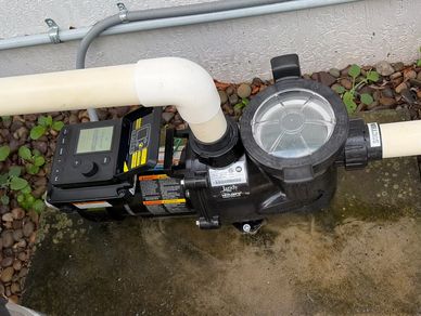 Jandy variable-speed pool pump with digital controls and connected PVC plumbing.