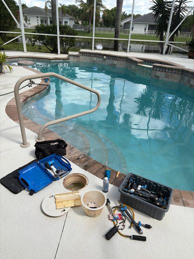     Pool leak-detection tools beside an open skimmer during a swimming pool inspection.