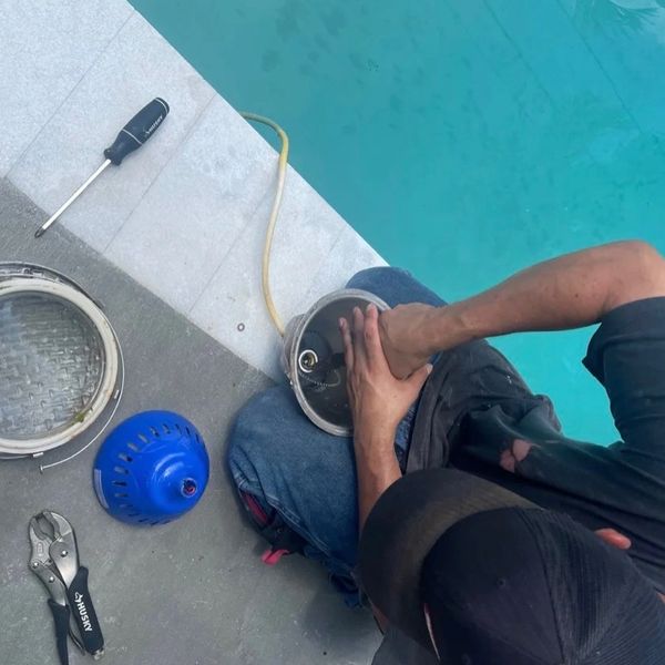 OC’s Pools technician servicing a swimming pool light in Broward County, Florida.