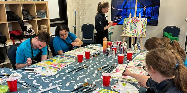 People engaged in a group painting activity.