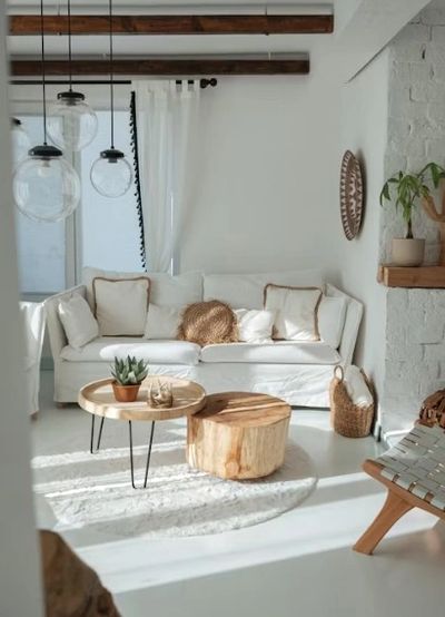 Bright living room with white sofa, wooden tables, and rustic decor.