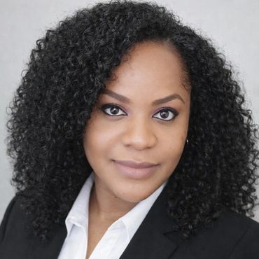 Professional woman with curly hair in a black blazer.