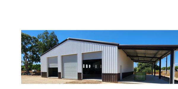 Pre-engineered metal building with 3:12 roof slope, 3 garage doors and an open sided lean-to cover.
