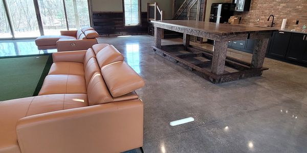 Modern rustic living area with leather couches and wood accents.