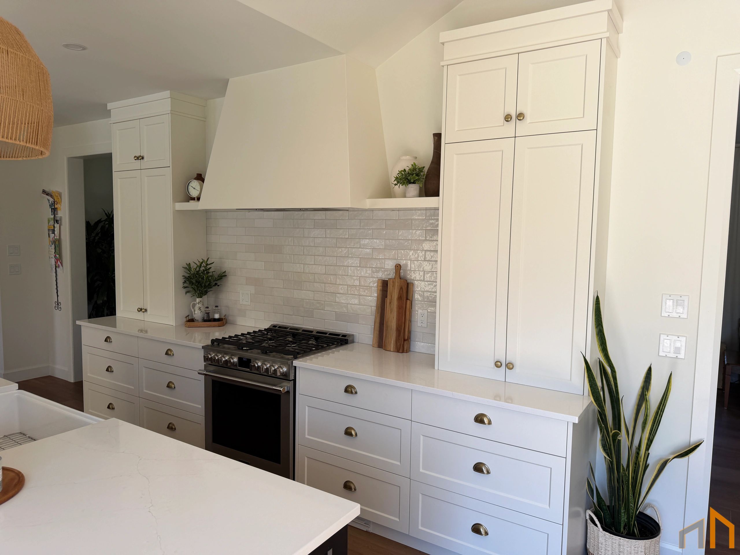 Modern white kitchen with ample cabinetry and a gas stove.