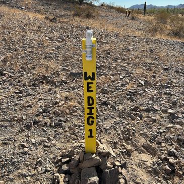 Yellow 4X4 wooden post for gold claim. Location monument containing claim papers in small, enclosed 