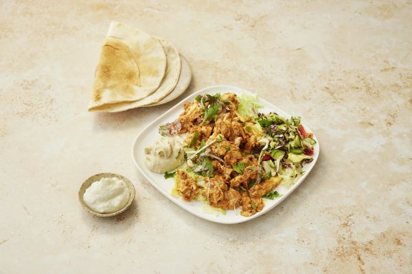 Chicken shawarma plate with hummus, garlic sauce, lettuce and bread