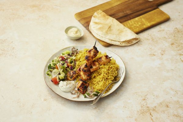 Chicken tawouk skewers with rice, garlic sauce, hummus and salad