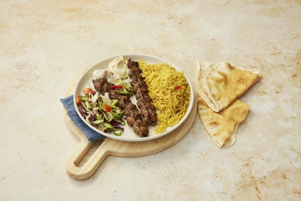 Kafta skewer platter with rice, hummus, garlic sauce and salads