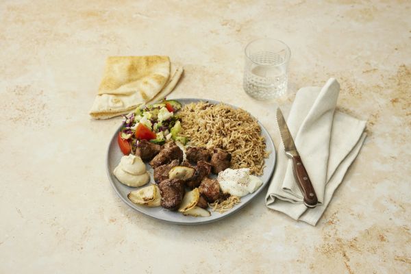 Lamb skewer platter with rice, hummus, garlic sauce and salads