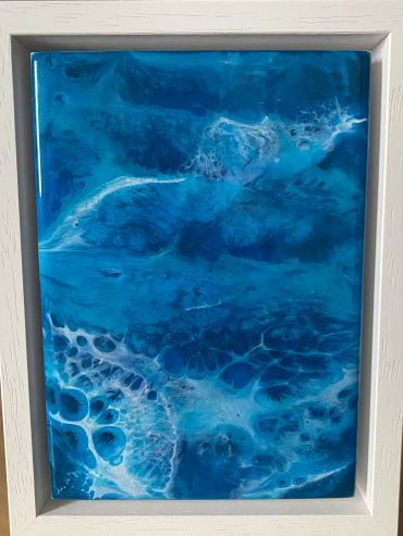 Abstract blue and white fluid art in a white frame.