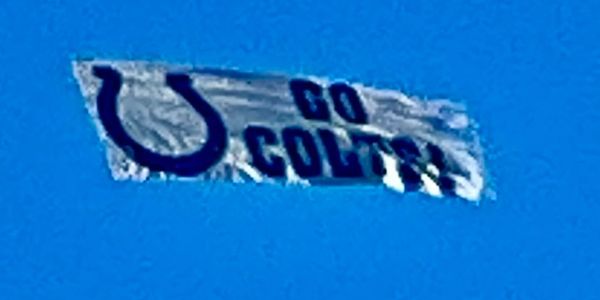 Banner with Colts logo and 'GO COLTS' text flying in the sky.