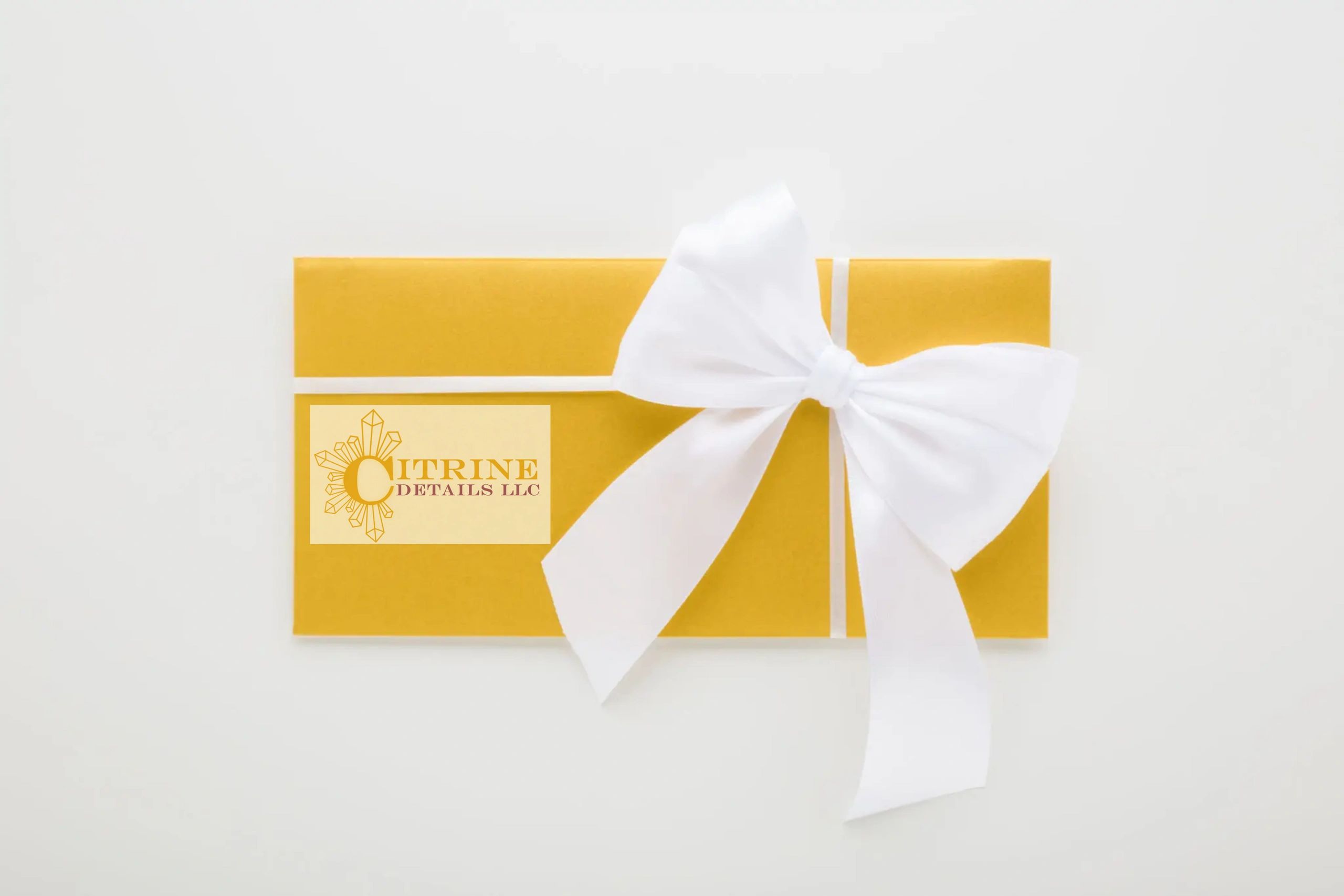 Elegant yellow gift box with a white bow and Citrine Details LLC logo.
