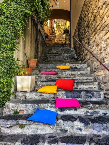 "Lake Como Cushions"  A shopkeeper put out cushions to rest upon after climbing the steep steps.