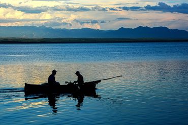 "Twilight Trolling."  Two fishermen in fading light in Cienfuego.